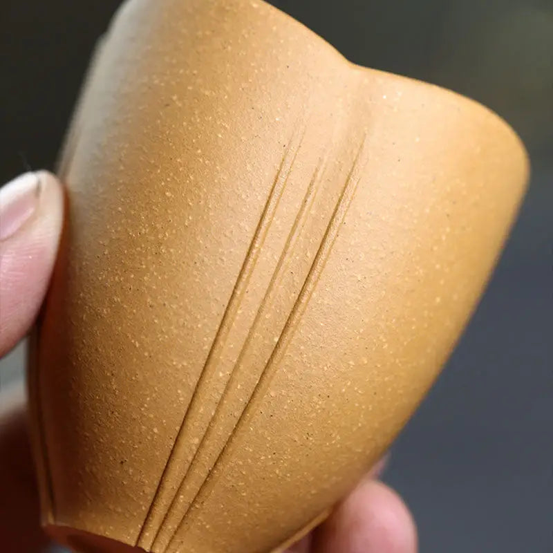 Textured brown Lotus Heart Zisha ceramic cup with carved lines, authentic Yixing style