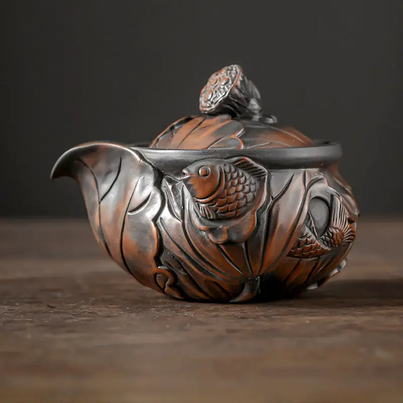 Ornate bronze-colored Lotus Pod teapot with fish and lotus designs, Jianshui Zitao style