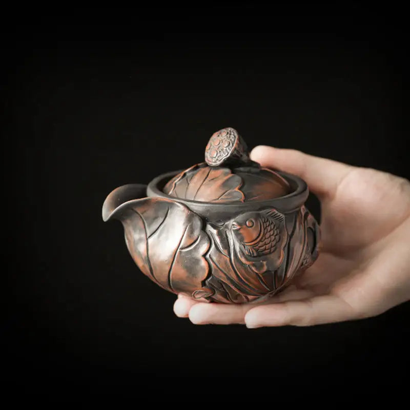 Ornate bronze Lotus Pod teapot with fish and lotus design, Jianshui Zitao style