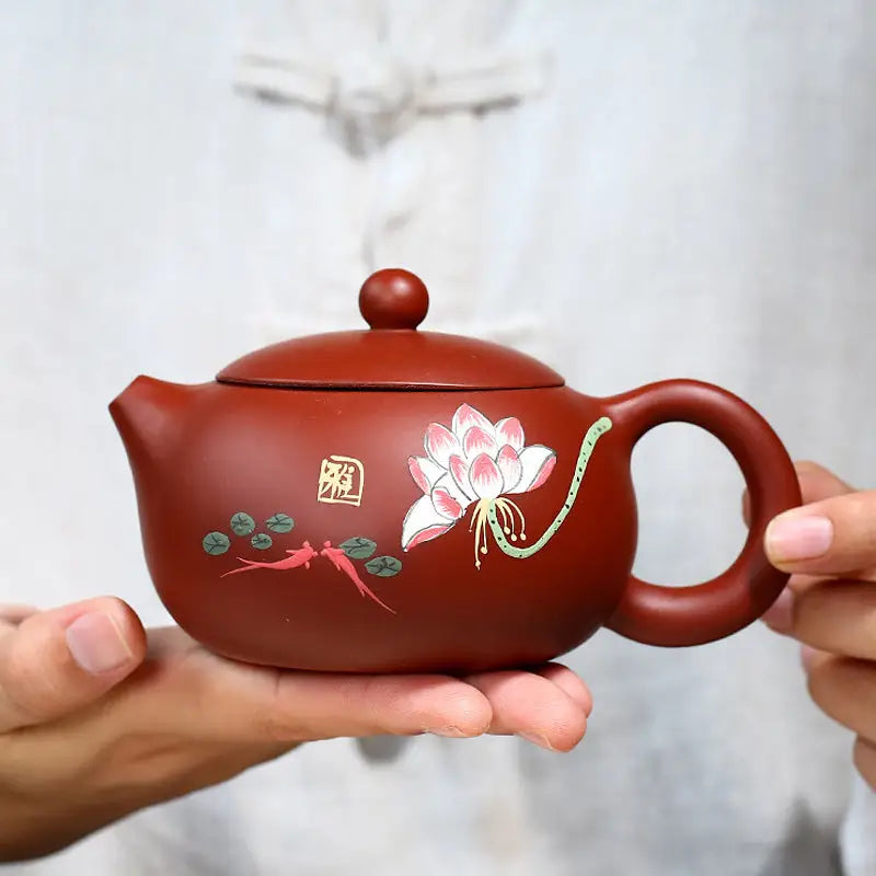 Reddish-brown Yixing Zisha teapot with hand-painted lotus design in purple clay