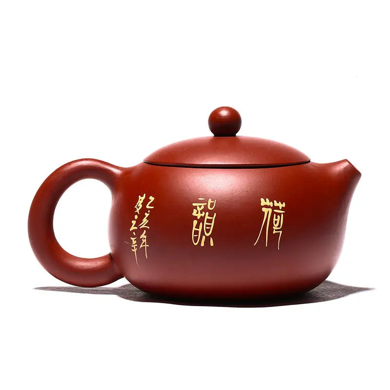 Yixing Zisha teapot with hand-painted lotus design in purple clay featuring gold lettering