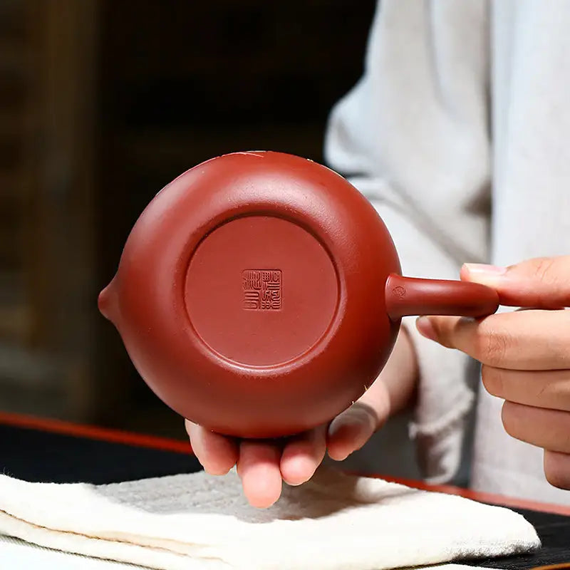 Red clay Yixing Zisha teapot with stamped base and hand-painted lotus design