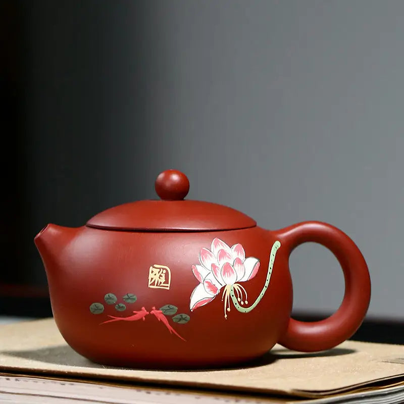 Reddish-brown Yixing Zisha teapot with hand-painted lotus flower design in purple clay