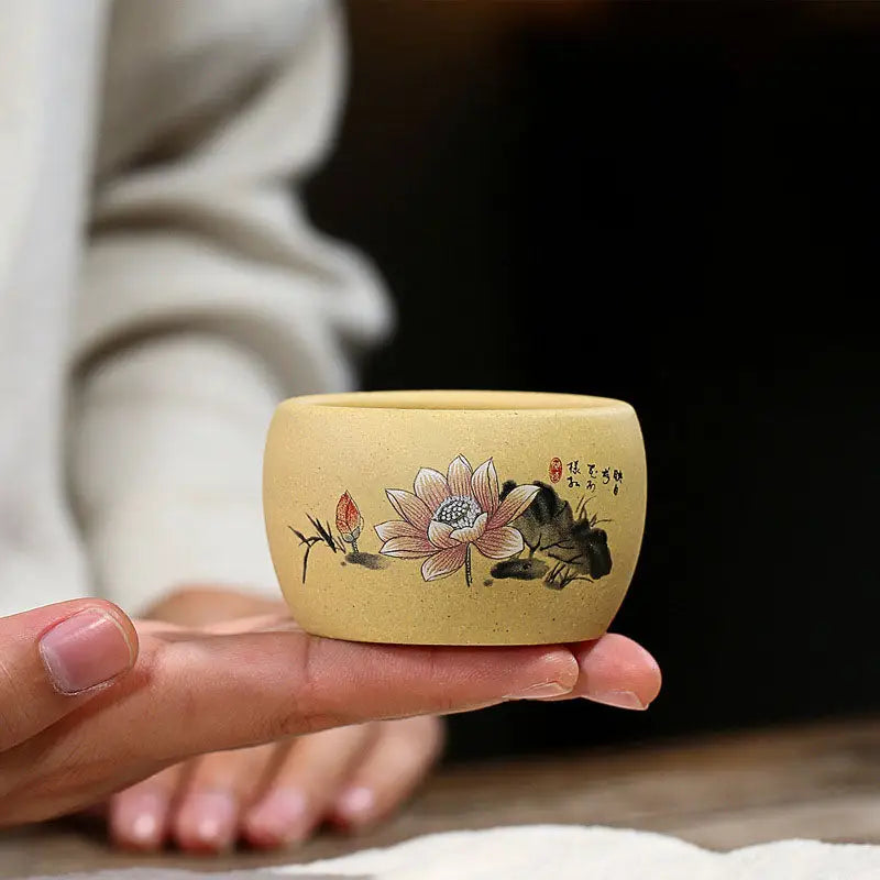 Small tan ceramic pot with lotus flower design, perfect for poetic calligraphy displays