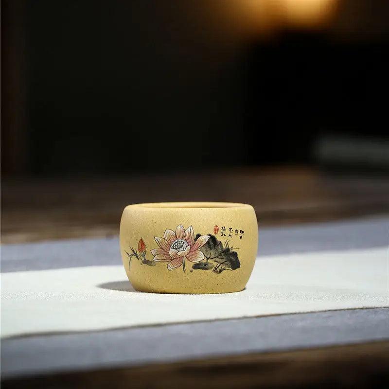 Round tan-colored pot with lotus flower design, perfect for poetic calligraphy displays