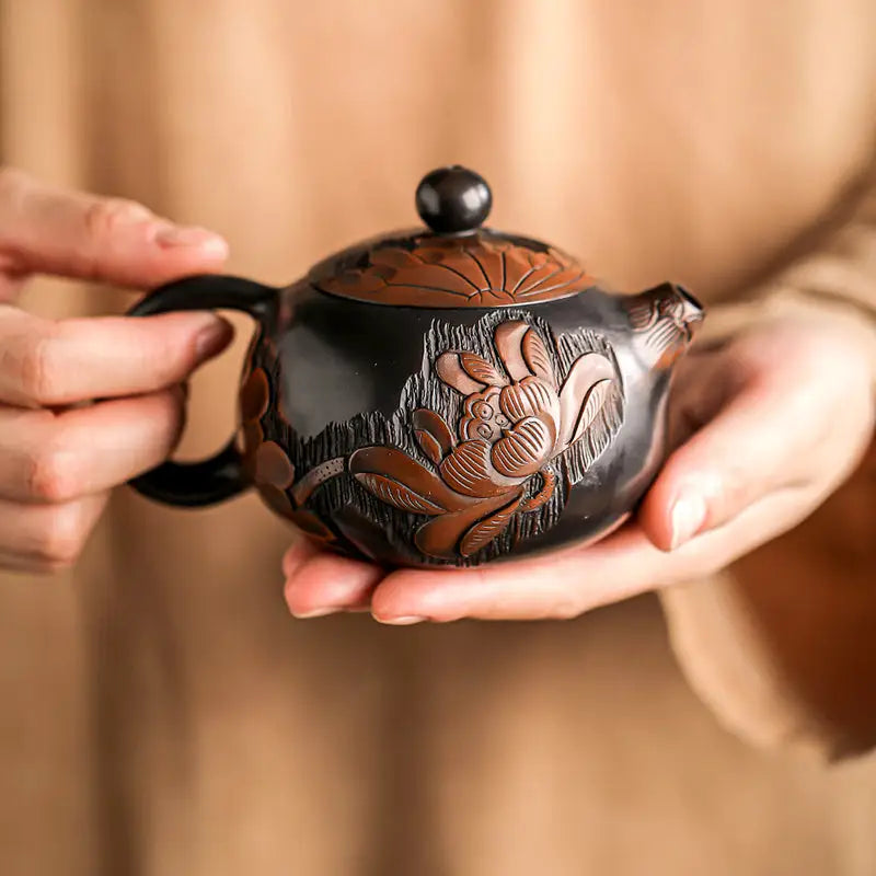 Dark-toned Zisha clay lotus teapot with ornate hand-carved floral designs
