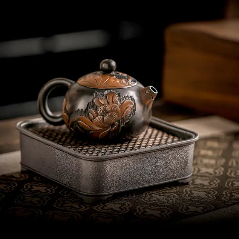 Ornate dark-toned Zisha clay lotus teapot with hand-carved floral design