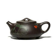 Brown Yixing Zisha teapot with hand-carved lotus design in Zisha clay for Lotus Whisper