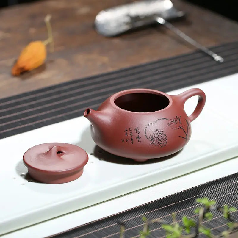 Reddish-brown Lotus Whisper Yixing teapot with lid featuring lotus pods design
