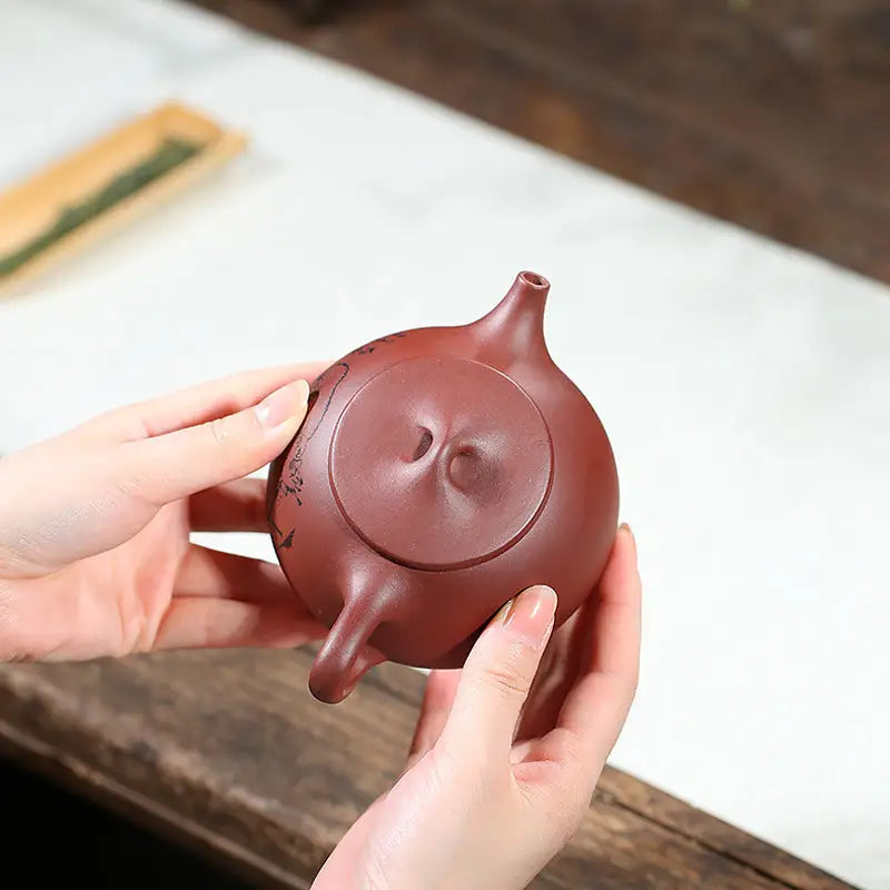 Maroon clay Lotus Whisper Yixing Teapot featuring lotus pods for elegant brewing