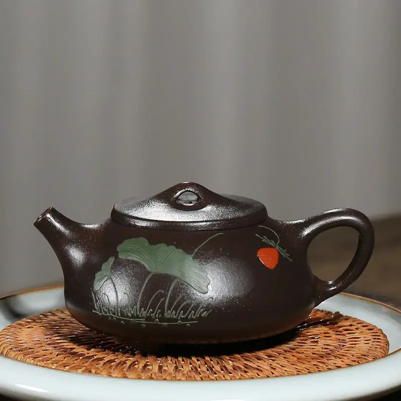 Brown Yixing Zisha teapot with hand-carved lotus design from Lotus Whisper