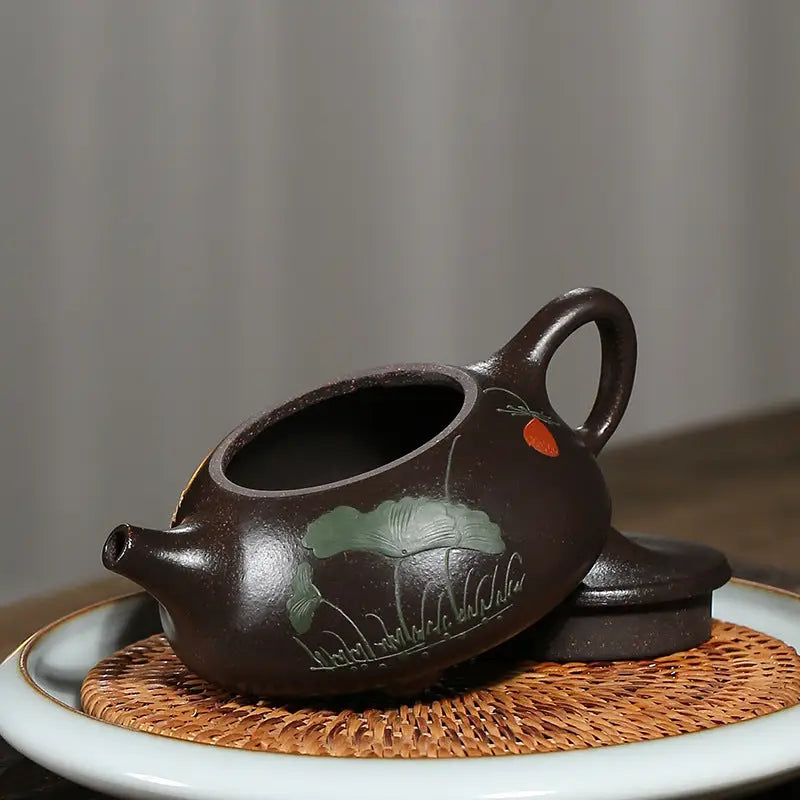 Brown Yixing Zisha teapot with hand-carved lotus design from Lotus Whisper