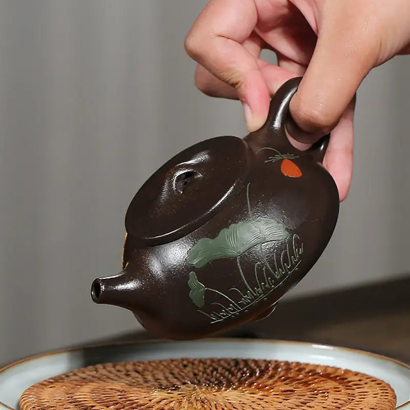 Brown ceramic teapot with floral design from Lotus Whisper, crafted in Yixing Zisha clay
