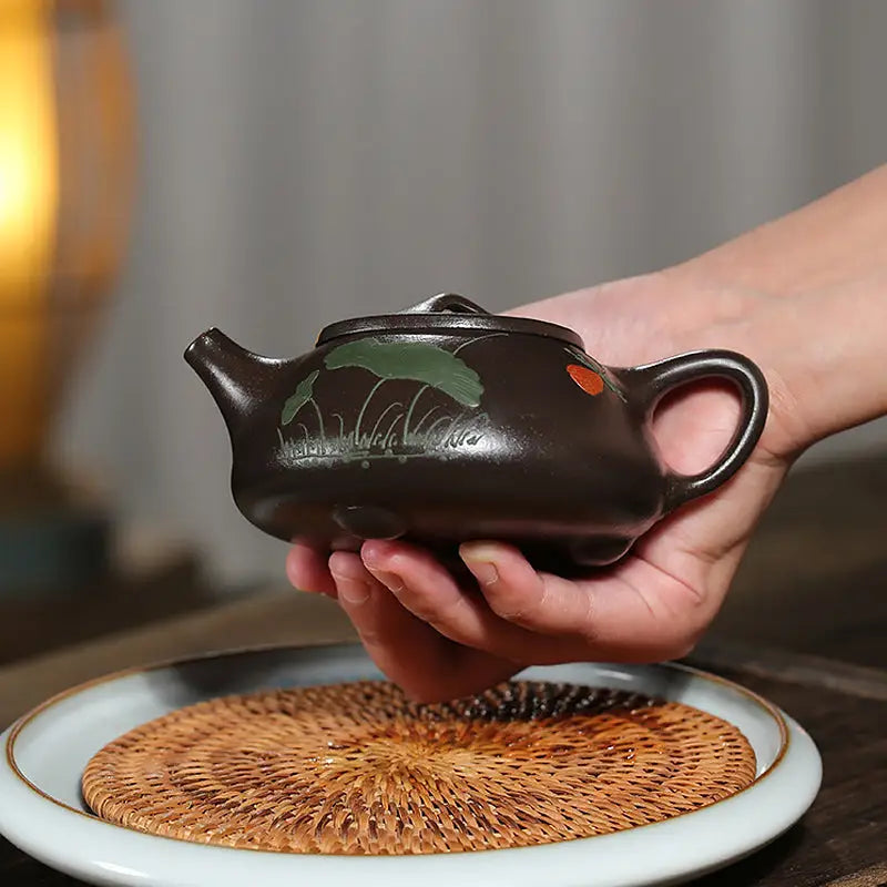 Brown ceramic teapot made from zisha clay in the Lotus Whisper hand-carved lotus design
