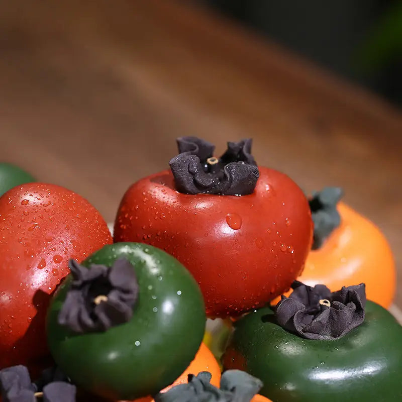 Colorful persimmon assortment featuring Lucky Persimmon tea pet and Zisha clay tea pot