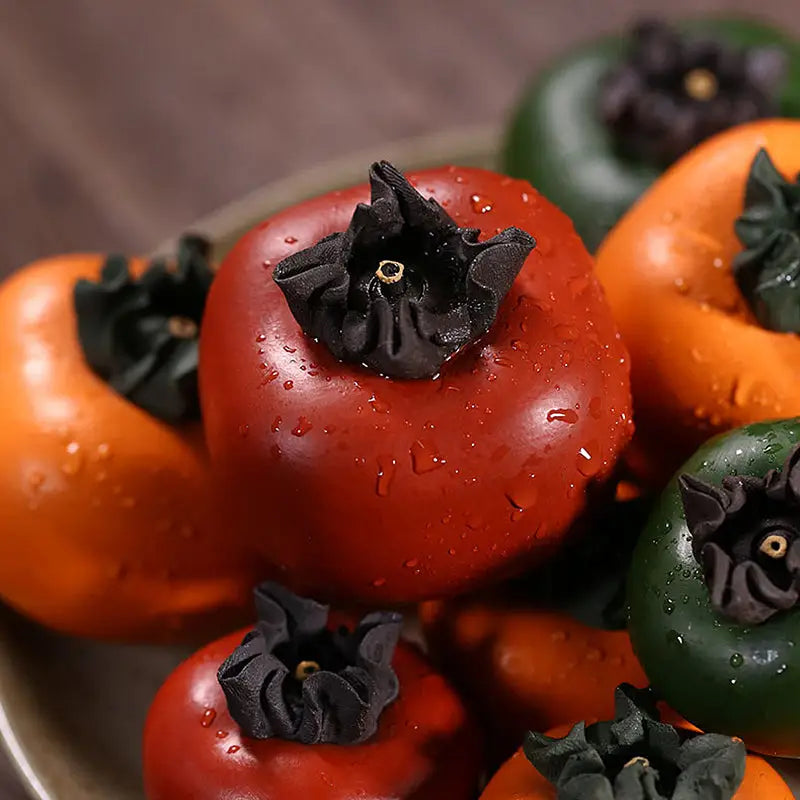 Colorful glossy persimmons with dark calyxes for Lucky Persimmon tea pet on zisha clay tea pot