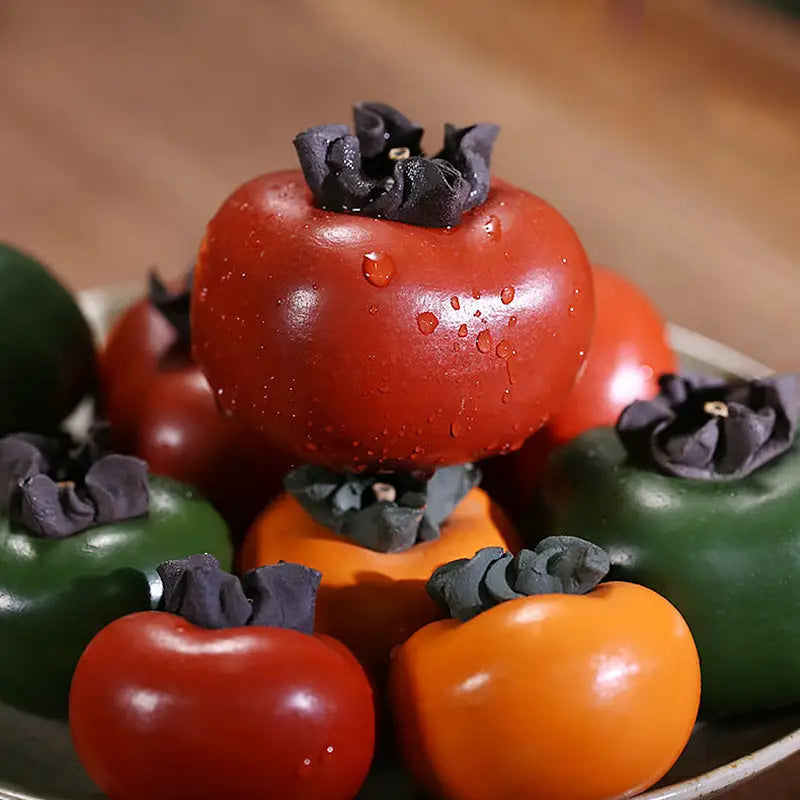 Colorful persimmon fruit pile with Lucky Persimmon Tea Pet and Zisha Clay Tea Pot