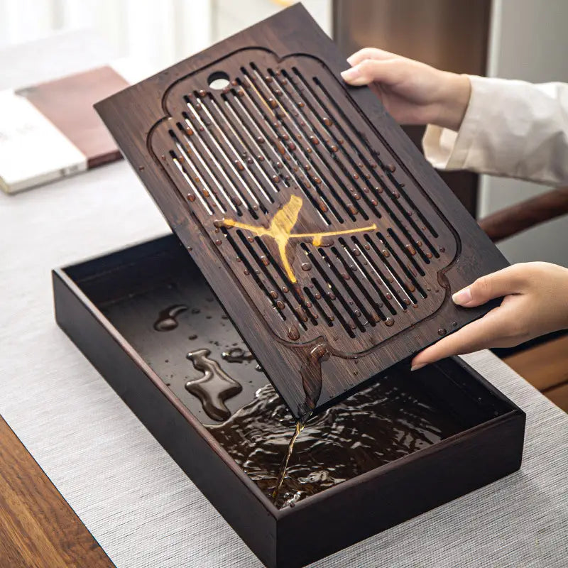 Dark wooden tea tray with drainage from Magpie Song bamboo tea tray collection