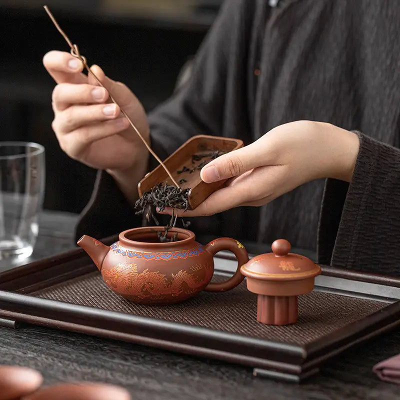 Earthenware Majestic Harmony Tea Set with Yixing Zisha teapot and pouring tea leaves