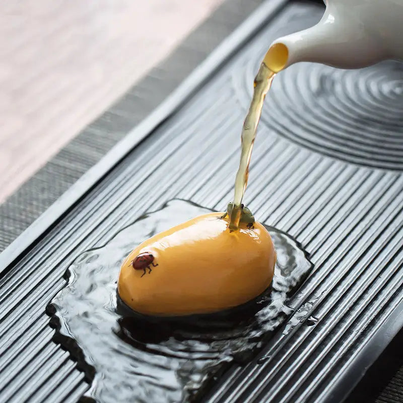Glossy yellow fruit with a ladybug, perfect for charming tea and feng shui tea pets guide