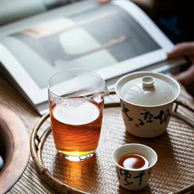Tea service on woven tray with Meizhan Jin Jun Mei Black Tea from Xingcun Village featuring Meizhan cultivar gold tips