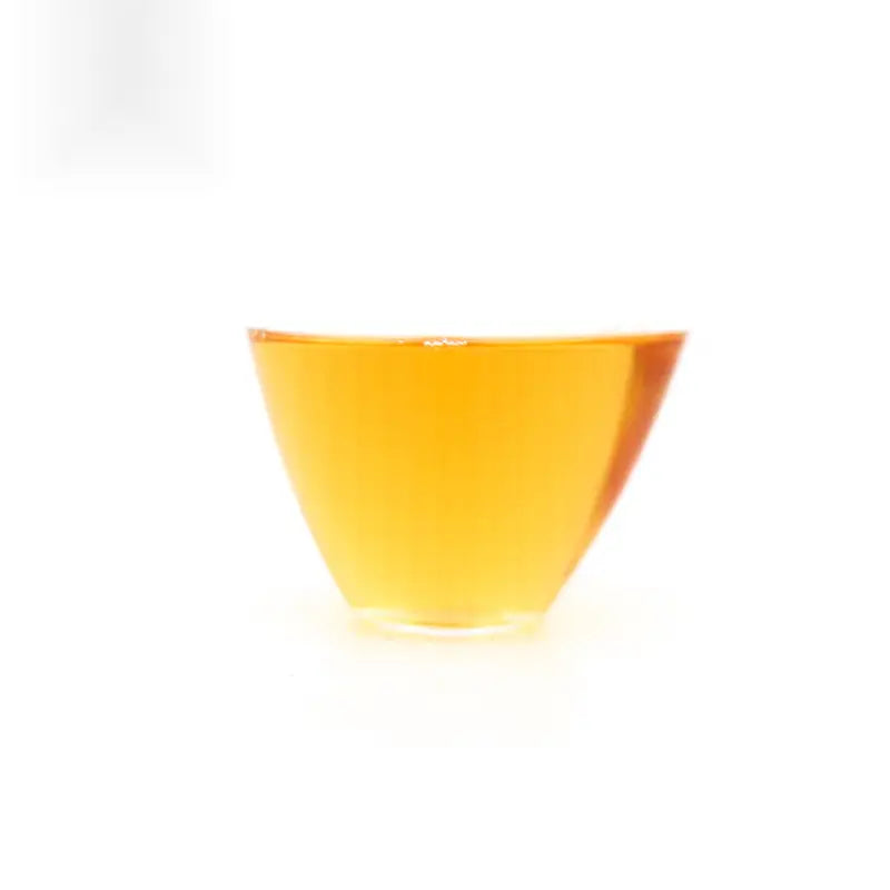 Triangular glass of amber Meizhan Jin Jun Mei Black Tea from Xingcun Village 2024 harvest