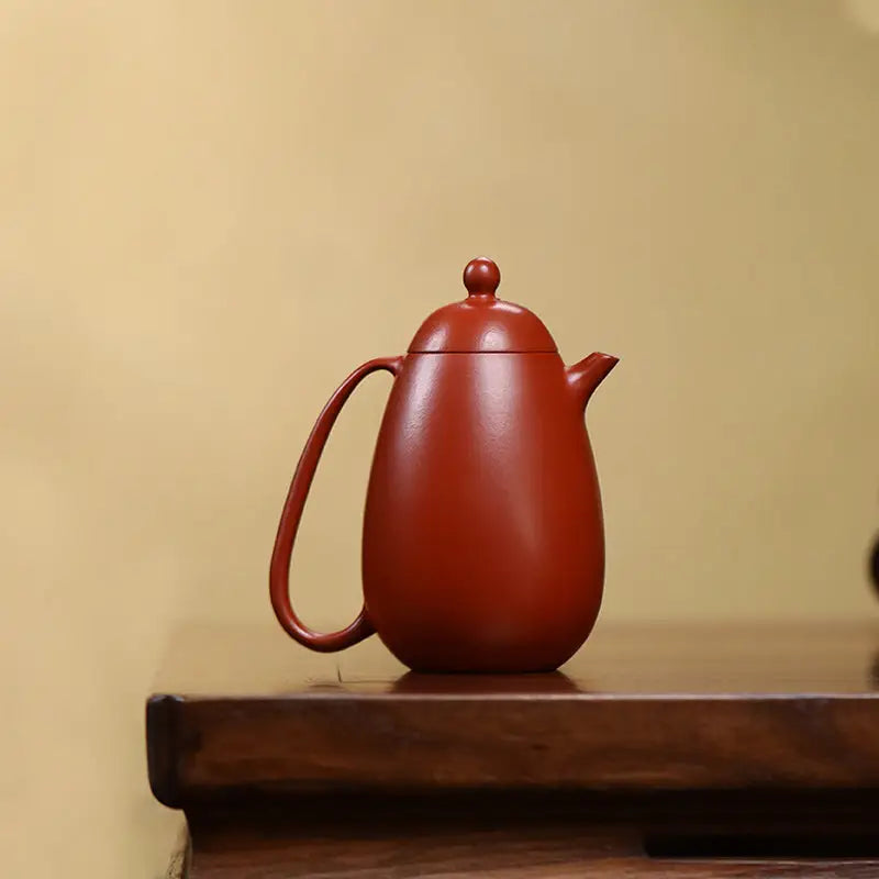 Red-brown ceramic Yixing teapot showcasing modern simplicity and red clay craftsmanship