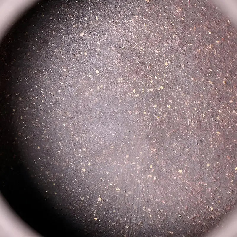 Yixing purple Moon Drop tea vessel with dark, speckled textured surface for tea rituals