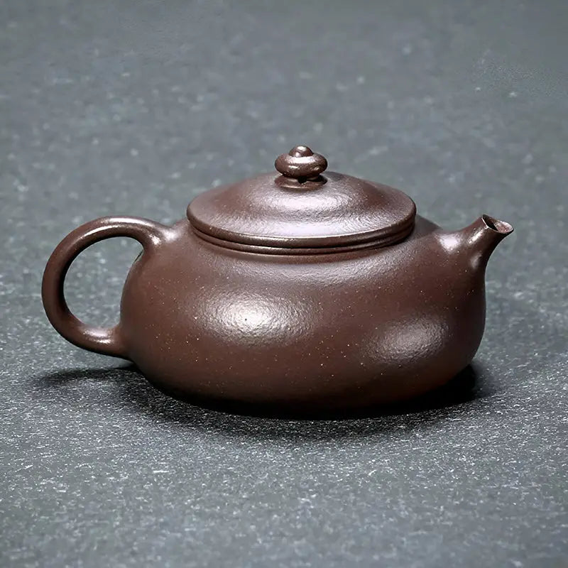 Brown clay teapot from Moon Drop showcasing Yixing purple clay for tea rituals