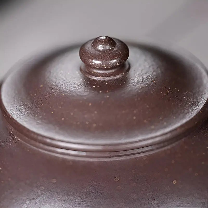 Brown ceramic teapot lid from Moon Drop for Yixing purple tea rituals