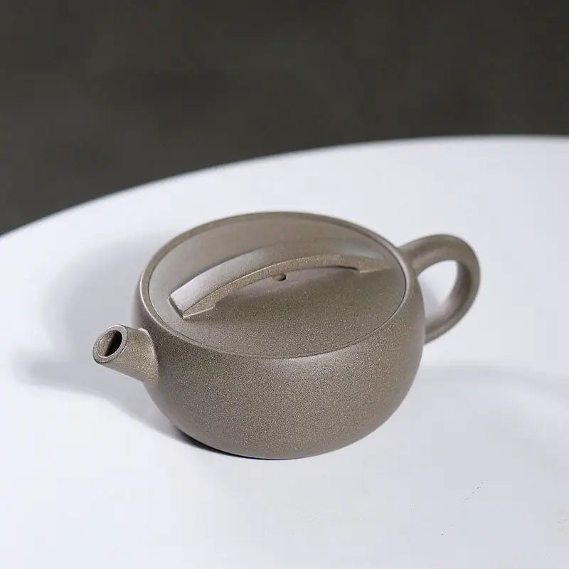 Round gray-brown Moonbridge harmony teapot with raised handle Yixing Zisha craftsmanship