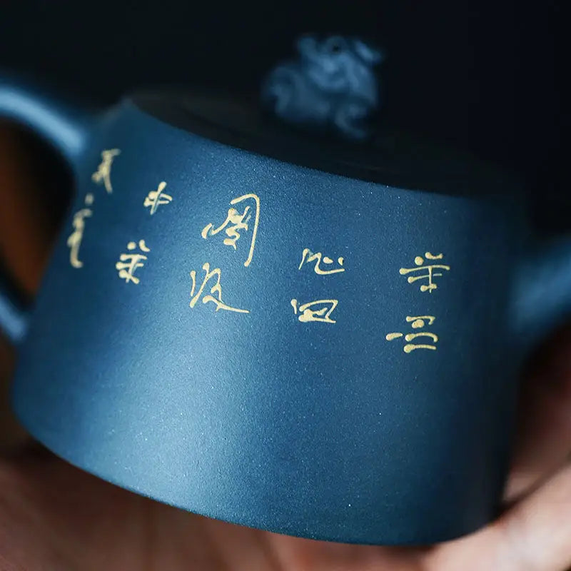 Blue ceramic teapot with gold lettering from Moonlit Guardian featuring White Plum Artwork