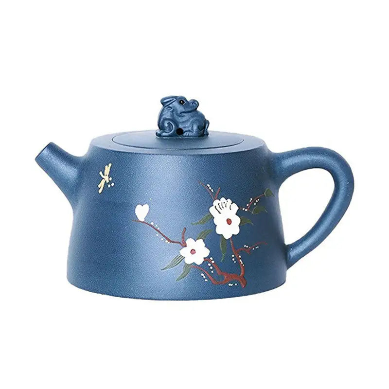 Blue ceramic teapot with floral design and animal lid inspired by Moonlit Guardian figurine