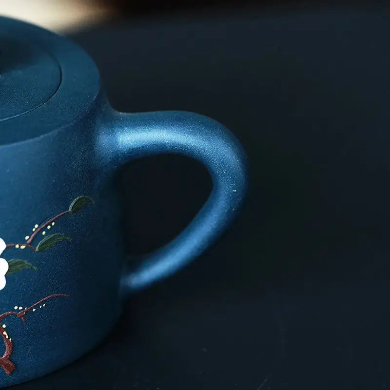 Blue ceramic teapot with floral design from Moonlit Guardian featuring White Plum artwork