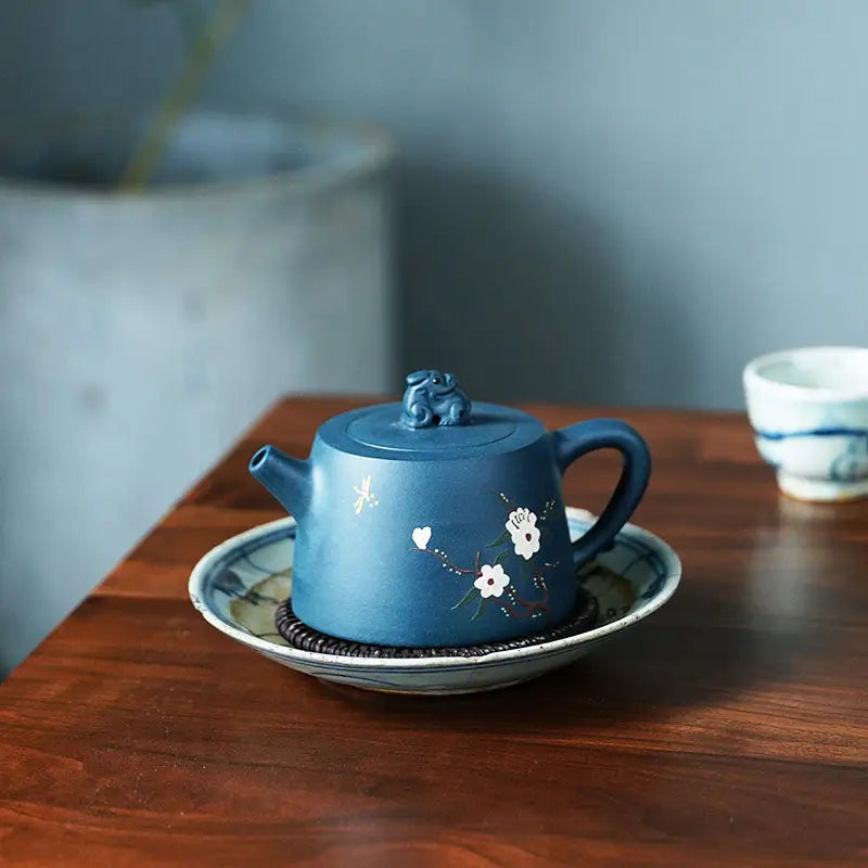 Blue ceramic teapot with floral design from Moonlit Guardian featuring White Plum Artwork