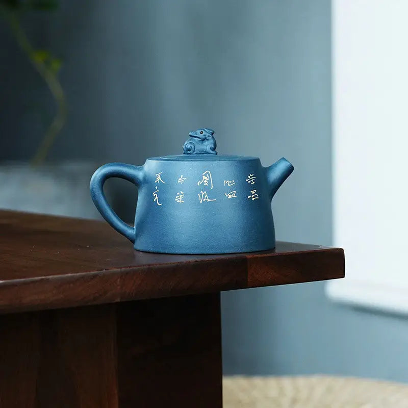 Blue ceramic Yixing Zisha teapot with Frog Moonlit Guardian figurine, inspired by White Plum artwork