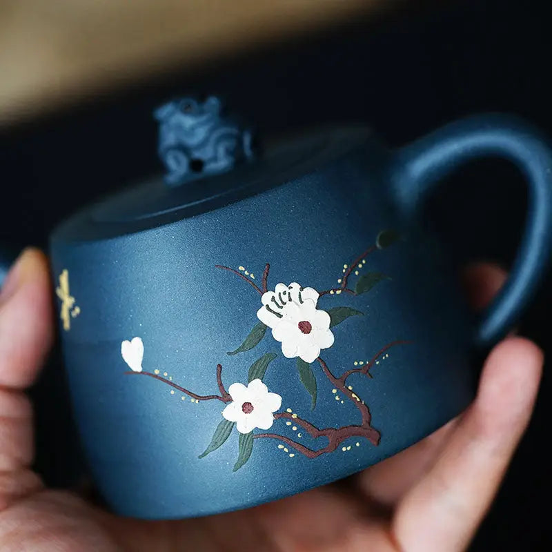 Blue ceramic teapot with floral design from the Moonlit Guardian figurine collection