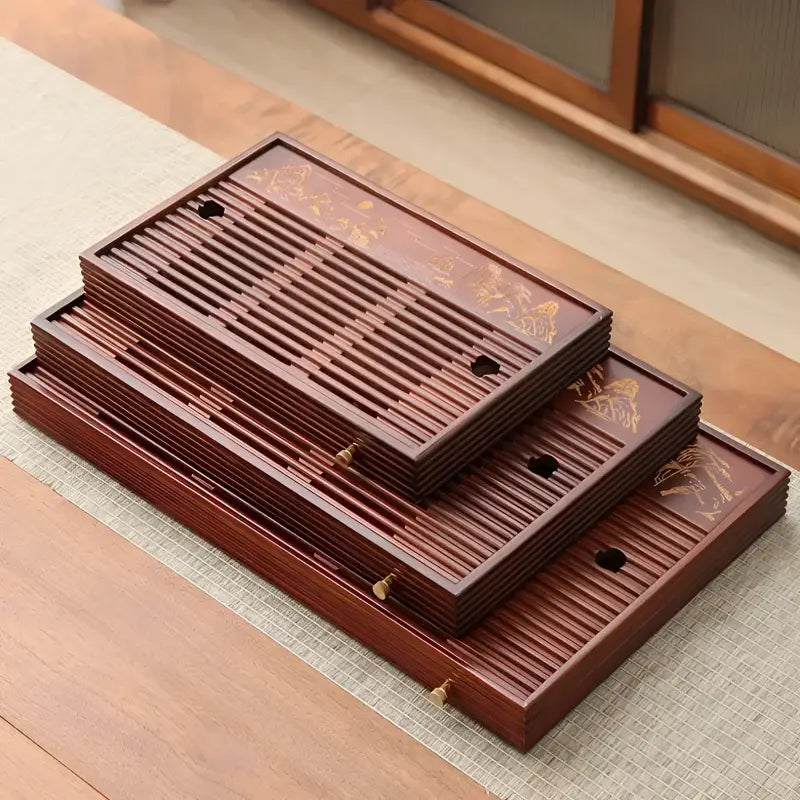 Stacked slotted dark wood tea trays from Mountain Flow bamboo gongfu tray collection