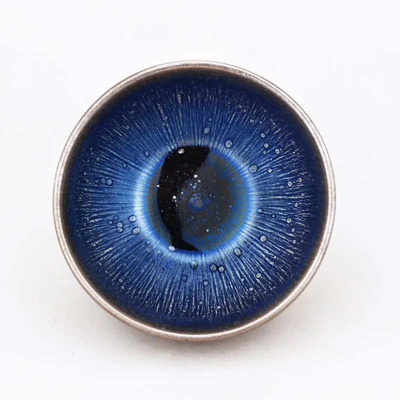 Round blue ceramic bowl with dark center showcasing Tenmoku glaze for Zhan tea serving