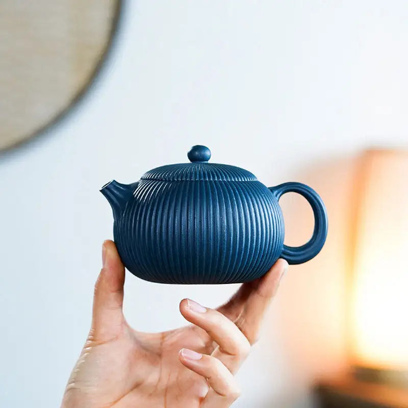 Blue ceramic teapot with vertical ridges in the Not Suitable product featuring a Midnight Ripple Yixing Zisha Teapot