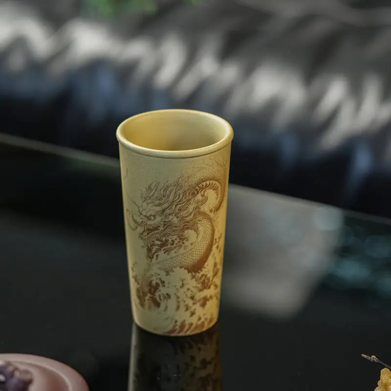 Ocean Dragon Yixing Zisha teapots featuring a dragon-etched cylindrical cup