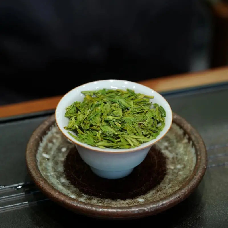 Cup of green tea leaves from Xitou Mountain in Old Tree Longjing – 2025 Spring Harvest