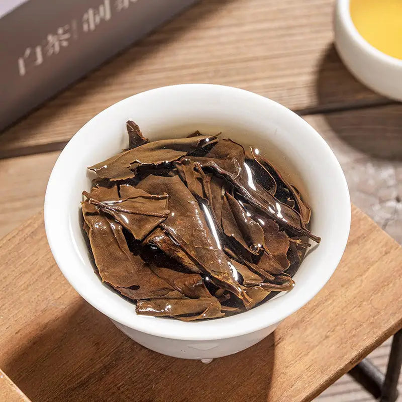 White bowl filled with steeped tea leaves, perfect for tea sets and enjoying tea time