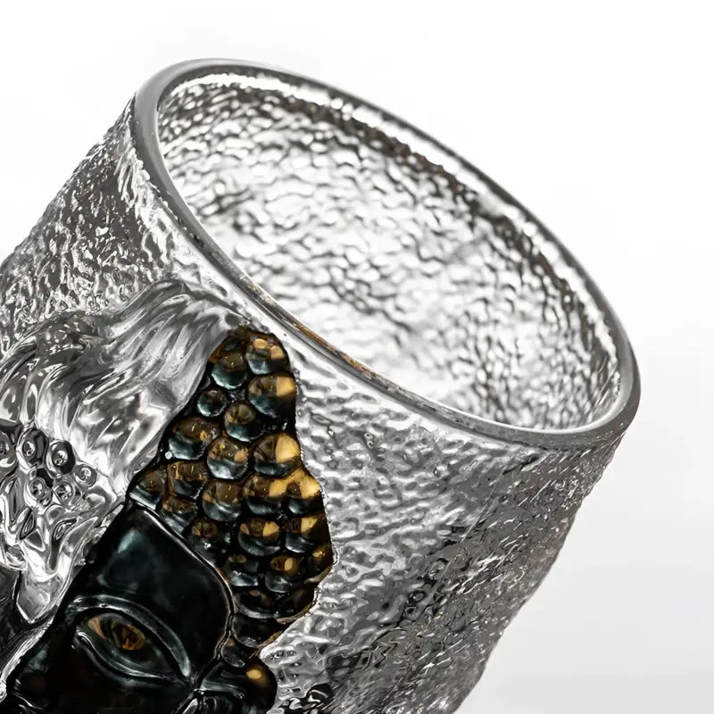Textured glass tumbler with ornate face from One Thought, showcasing Buddha ice crackle and spiritual symbolism