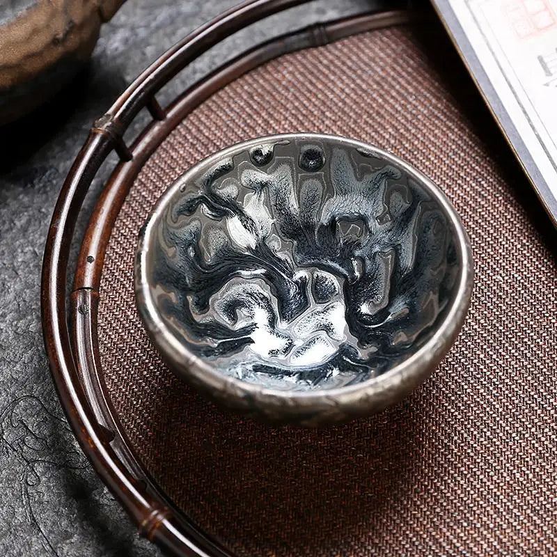 Silver Oni teacup with swirling patterns, perfect for Jian Zhan tea ceremonies