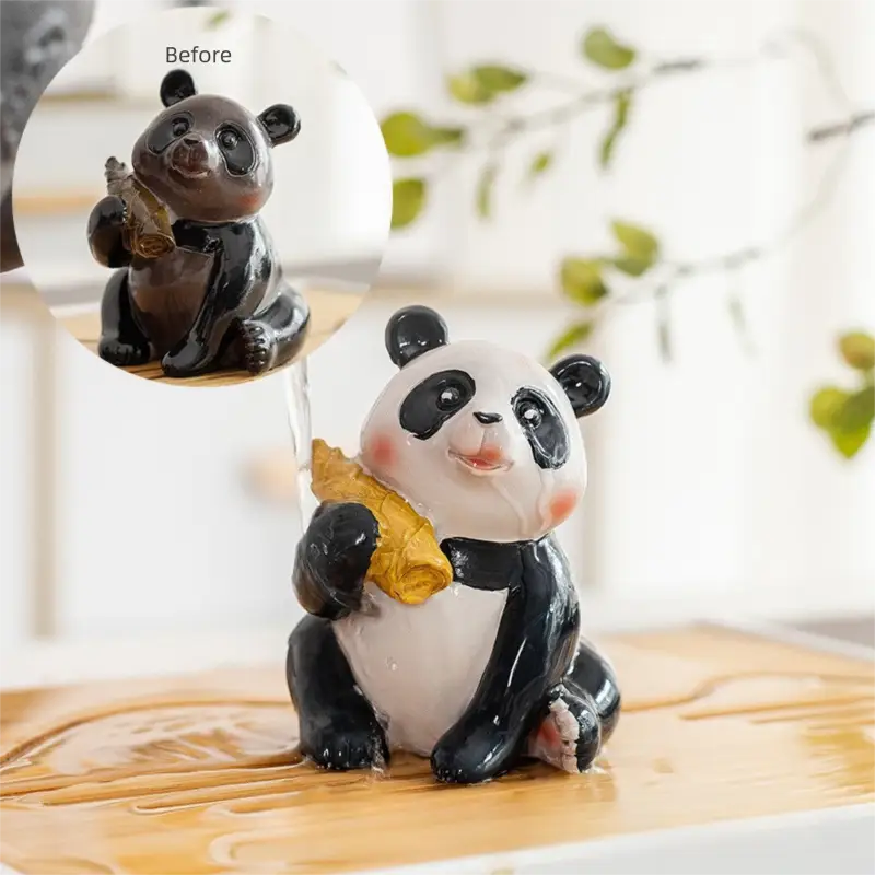 Color-changing panda tea pet figurine holding a golden object made from eco-friendly resin for feng shui tea table