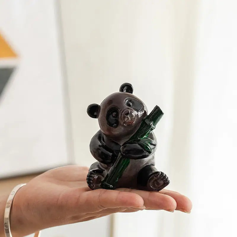 Glass panda figurine holding bamboo, perfect as a feng shui tea pet or eco-friendly resin tea table decor