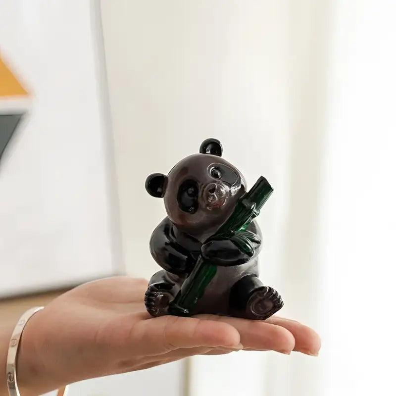 Glass panda figurine holding bamboo, perfect as a feng shui tea pet or eco-friendly resin tea table decor
