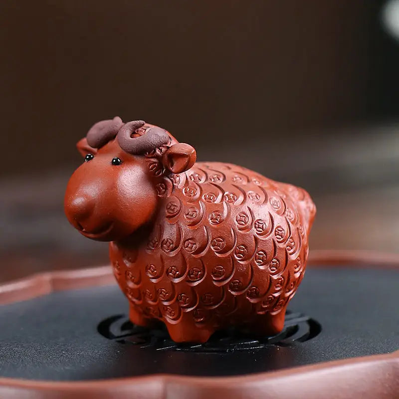 Reddish-brown ceramic sheep figurine from Peaceful Ram, ideal for tea pets guide and feng shui