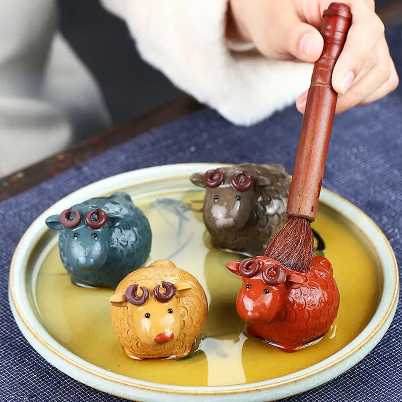 Colorful sheep figurines with brush from Peaceful Ram Tea Pets Guide in Zisha clay for feng shui